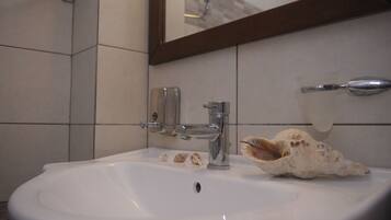 Shower, hair dryer, towels, toilet paper