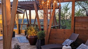 A wooden deck with a pergola, outdoor seating, and potted plants. - Glass Treehouse W/ Views-EPIC POOL-Kayak-SUP-HIKES-Restaurants ,Airy Exotic vibe (Austin)