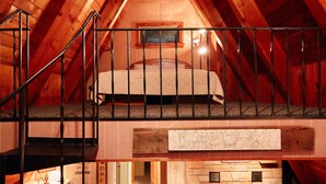 A loft-style bedroom with a loft bed, a fireplace, and a staircase. - Private Mohican Riverfront - Popular Location/Loved by Guests (Loudonville)