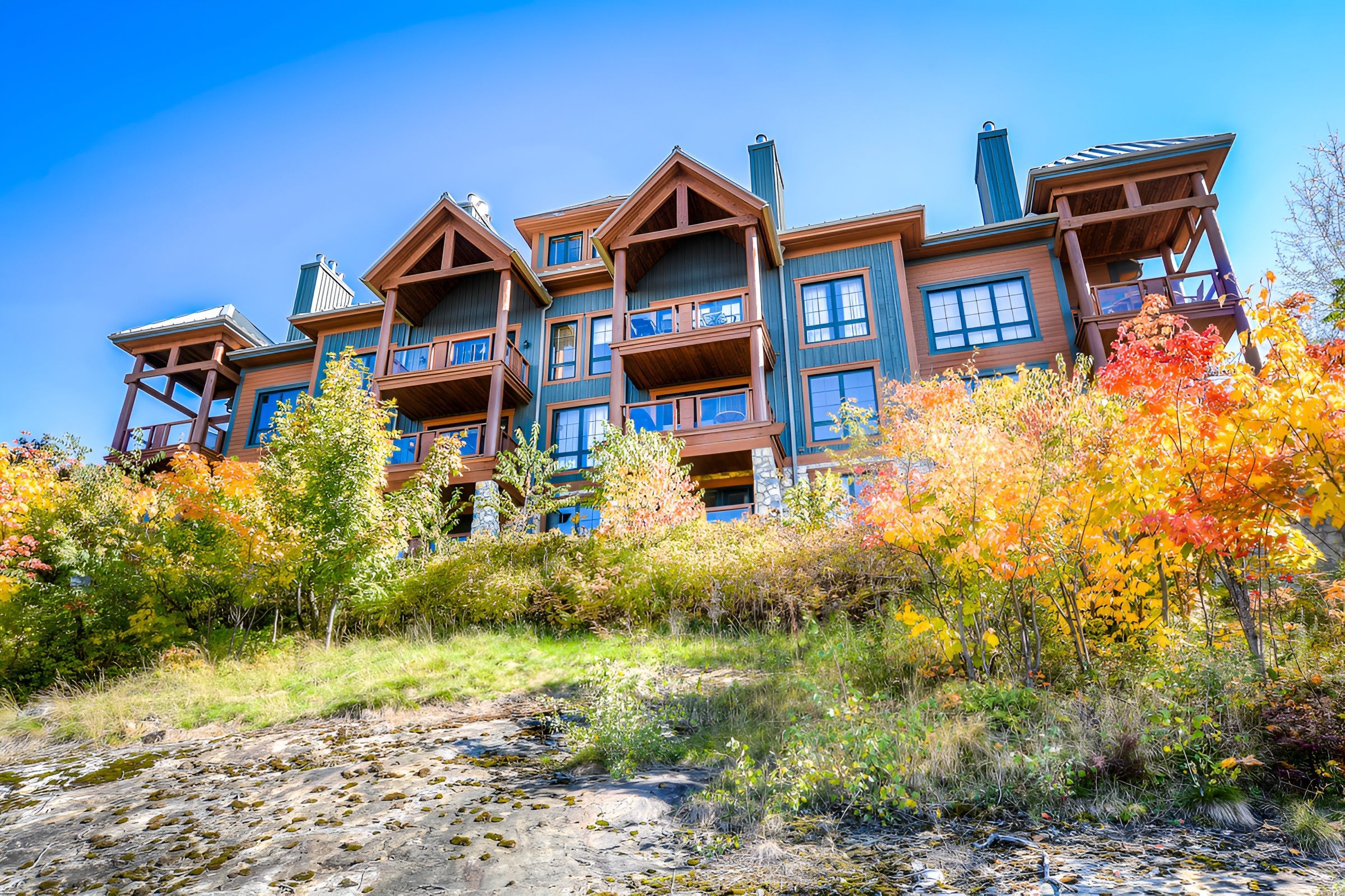 A multi-story lodge with balconies and a stone facade.