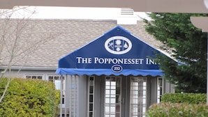 A building with a blue awning labeled "The Popponeset Inn" and the number 252. - Great SUMMER WEEKS Available! (New Seabury)