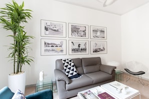 Relax in this stylish living room with a sofa, coffee table, and comfortable chair.