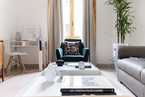 Relax in a serene space with a comfortable armchair, sleek sofa, and a coffee table.