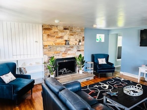 Smart-tv, eldstad, böcker och kontor