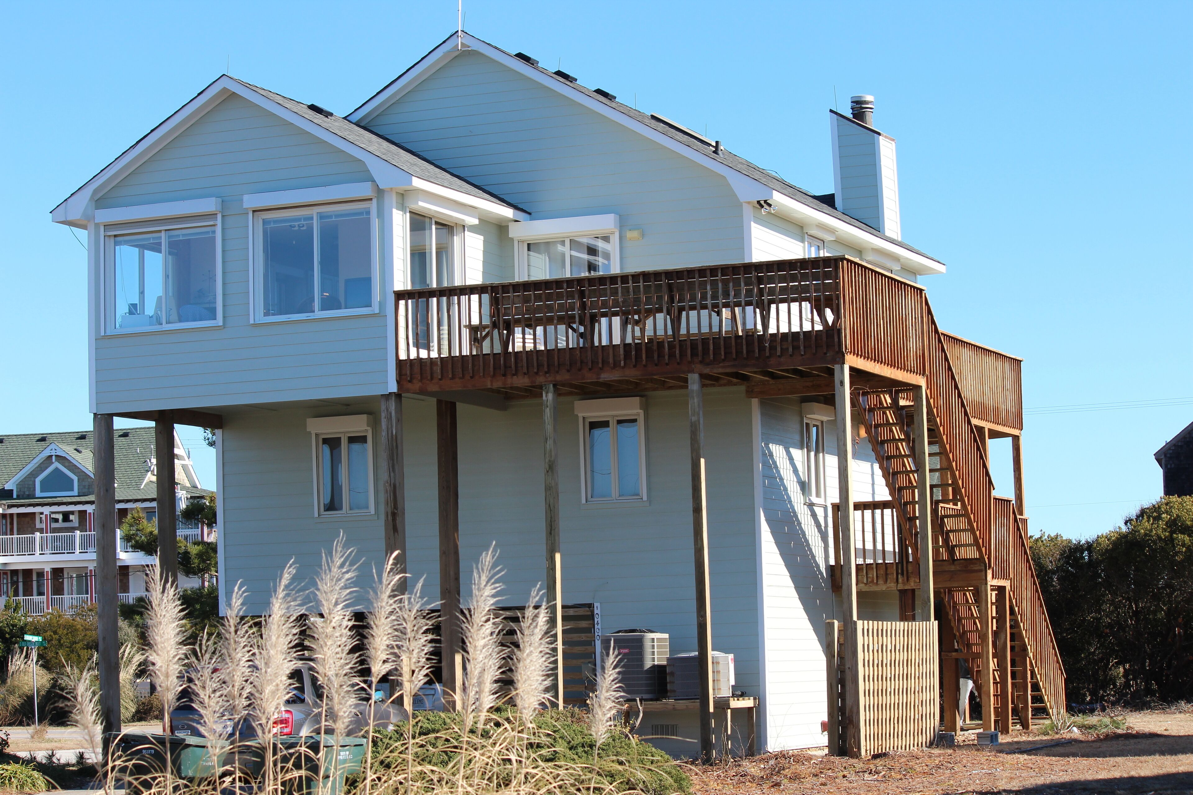 A two-story house with a balcony and a staircase leading to the upper floor.
