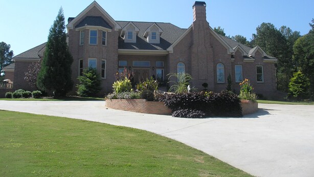 A large, two-story brick house with a prominent chimney, a driveway, and well-maintained landscaping. - Mansion - 20 mins to Airport /  20 mins  to Downtown Atlanta & Buckhead (Ellenwood)