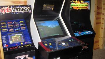 Experience the thrill of classic arcade games in our gaming area, featuring a selection of iconic titles.