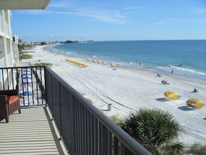 A beach with umbrellas and people. - Special Aug 29 to Sept 05, 2026 - Madeira Direct Beach Front Corner Condo (Madeira Beach)