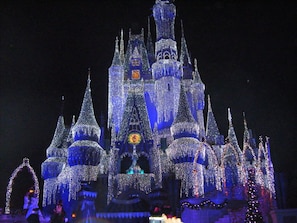 A castle-like structure with multiple spires and a clock, illuminated with lights. - Special Aug 29 to Sept 05, 2026 - Madeira Direct Beach Front Corner Condo (Madeira Beach)
