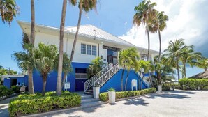 A building with a sign reading "Kaibo Yacht Club" and a staircase leading to the entrance.