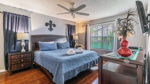 A bedroom with a bed, nightstands, a desk, a ceiling fan, and a window with curtains. - Welcome To Potter's Castle! Near Disney, Slps 8, Harry Potter Decor, Pool, WOW! (Kissimmee)