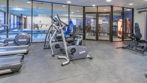 A gym with cardio machines, a weight bench, and a Coca-Cola vending machine. - A+ ski-in/out REMODEL NOW 2026 @ PC pool/gym/hot tub/washer/wifi/fireplace (Park City)