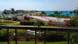 A resort with a pool, a bridge, and a view of the ocean and sailboats. - Tropical Gem! Watch Jets Fly into Airport+Ocean Beach+Garden Views+MANY PERKS!!! (Maho Bay)