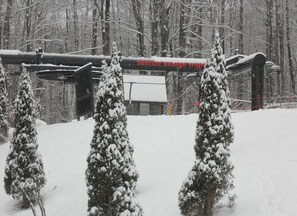 A snowy landscape with a sign for 'Sunrise Village Inn.'