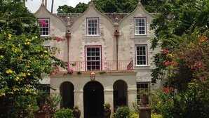 A colonial-style building with a symmetrical facade, arched entrance, and a balcony with a railing. - Beachfront penthouse, Speightstown, stunning West Coast, full AC, near amenities (Speightstown,)
