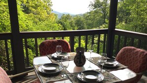 A table set for two with a scenic view of trees and mountains. - Enjoy Amazing Smoky Mountain View in Large, Comfortable Home in Treetops! (Franklin)