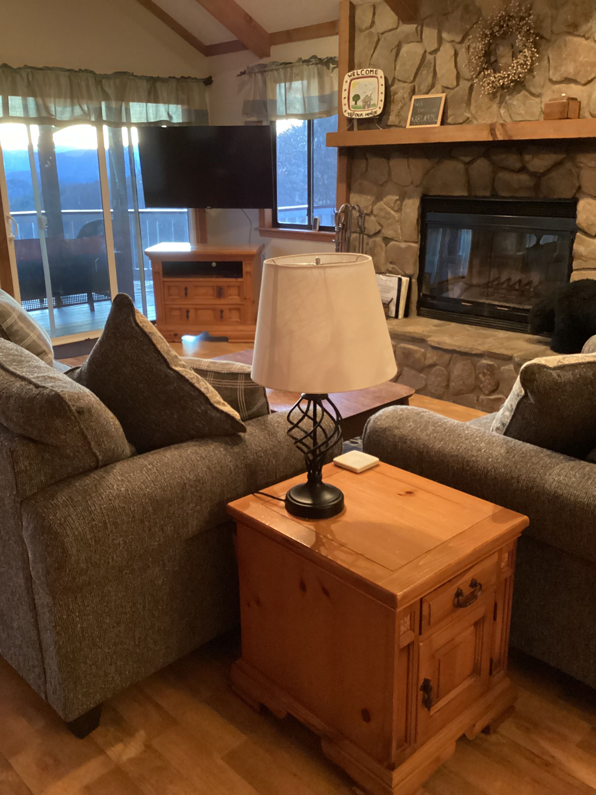 A cozy living room with a fireplace, a television, and a wooden coffee table.