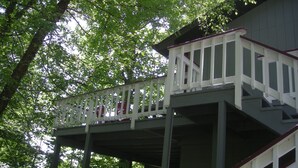 A multi-level wooden deck with white railings, surrounded by trees. - Enjoy Amazing Smoky Mountain View in Large, Comfortable Home in Treetops! (Franklin)