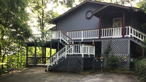 A two-story building with a covered porch and a staircase. - Enjoy Amazing Smoky Mountain View in Large, Comfortable Home in Treetops! (Franklin)