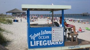A lifeguard station with a sign indicating beach warnings. - Lighthouse Cottage--1.5 blocks from beach.  (Tybee Island)