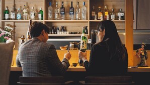 A bar with shelves of liquor bottles and a decorative item on the counter.