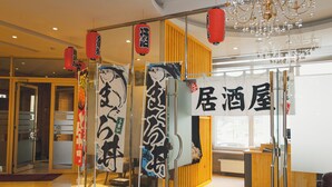 A reception area with glass doors, red lanterns, and a sign with Japanese characters.