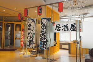 A reception area with glass doors, red lanterns, and a sign with Japanese characters. - Springs Hotel Ulaanbaatar (Ulaanbaatar)
