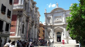 A historic building with classical architecture, including columns and statues.