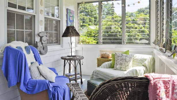 A cozy sunroom with a 'BEACH' sign, wicker furniture, and a view of greenery. - Wonderful location, walk to beach, private yard, Voted #1 in town by AB&B (old saybrook)