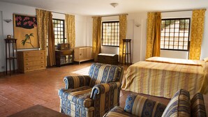 A room with a bed, two armchairs, a wooden table, a dresser, and a radiator. - Relax with pool and see view! (Altavilla Milicia)