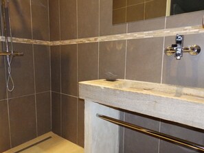 Bathtub, hair dryer, towels, toilet paper