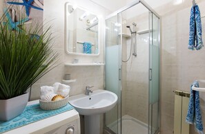 Bathtub, hair dryer, bidet, towels