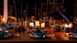 A table set for a meal with wine glasses, bowls, and candles. - Luxury modern family villa with lagoon views, private heated pool, free wifi  (Foz do Arelho)