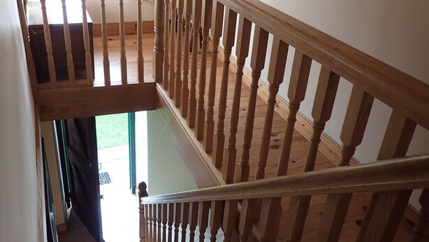 Una escalera de madera con vistas al piso superior.