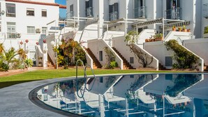 A modern pool area with a clear view of the surrounding buildings, including a staircase leading to a balcony. - GREAT HOUSE IN PARADOR AREA WITH POOL AND SEA VIEWS CLOSE TO BURRIANA AND CITY (Nerja)