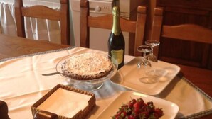 A dining table set with a cake, strawberries, a bottle of wine, and glasses. - REFINED RUSTIC WITH A TASTE COUNTRY CHIC IMMERSED IN AN OASIS OF PEACE (STAZZEMA)