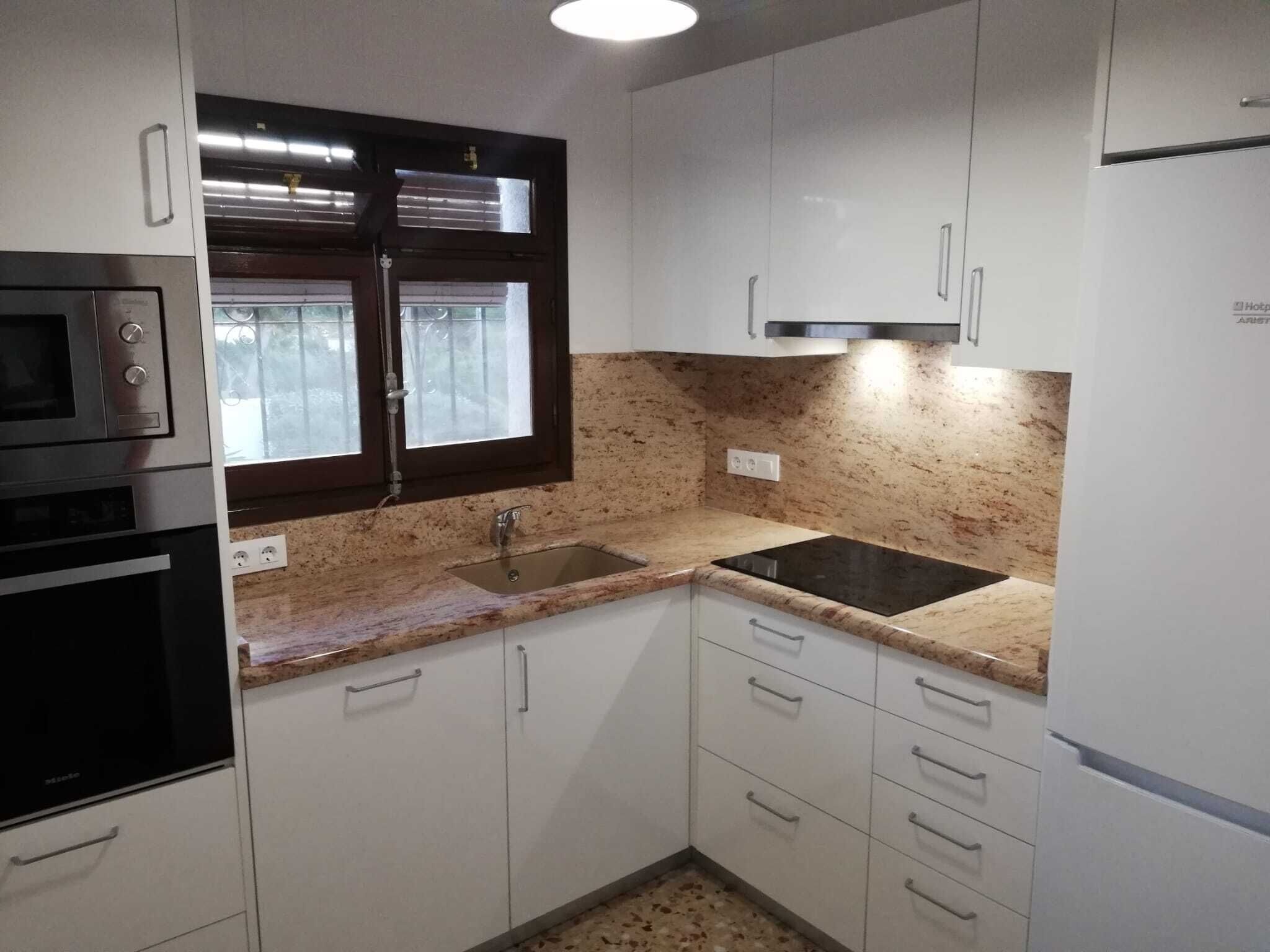 A kitchen with white cabinets, a black stove, a window with blinds, a sink, and a countertop.