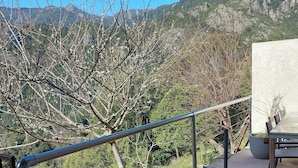 A balcony with a metal railing overlooking a mountainous landscape. - U vene e posa - the Pinzelli mountain.  (Lugo-Di-Nazza)