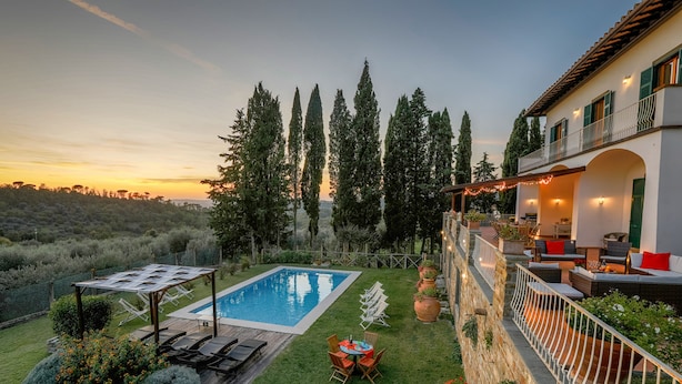 A pool area with lounge chairs, a table, and a pergola. -  "Villa Torre in Chianti"  Vrbo Vacation Rental of the Year 2026- 8 bedrooms A/C (San Casciano in Val di Pesa)
