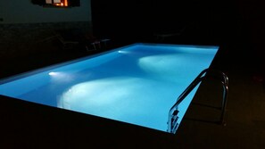A swimming pool with a ladder on the right side.