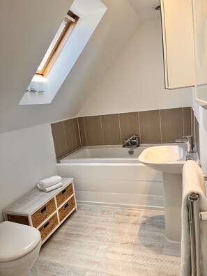 Combined shower/bathtub, hair dryer, towels, soap