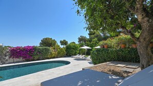 A swimming pool with a tiled deck, surrounded by lush greenery and a pergola with umbrellas. - New house: Heated swimming pool, large BBQ, 100MB wifi, air conditioning (Tosalet, El (Javea/Xabia))