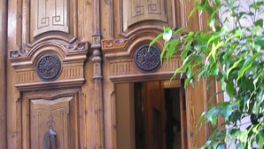 A wooden door with intricate carvings and a brass knocker. - Unmatched Luxury next to the  Cathedral - Valencia (València)