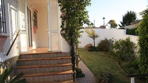 A set of outdoor stairs with patterned tiles leading to a building entrance, surrounded by greenery and a well-maintained lawn. -  Semi-secluded 3 Bed, 2 bath Tranquil Family Villa with Pool & Gardens  (Estepona)