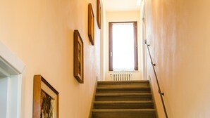 Una escalera con barandilla que lleva a una puerta al final.
