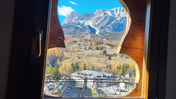 Een uitzicht op een bergachtig landschap, een vallei en een klein dorp.