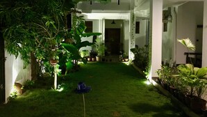 A well-maintained courtyard with a variety of potted plants and a small garden area. - Cozy Bay (Arugam Bay)