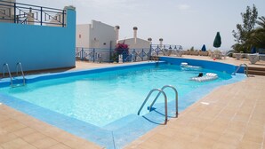 A swimming pool with a blue border, metal railings, and a tiled deck. - Fantastic Views Amadores, Wifi (Mogán)