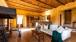 A cozy living room with a white sofa, wooden coffee table, and a fireplace. - Il Poderuccio 17, Emma Villas (Cetona (Siena))