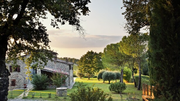 A rustic stone building with a stone pathway leading to a circular stone fountain. - Secluded villa between Chianti vineyards, private pool, tennis, large garden (Gaiole In Chianti)